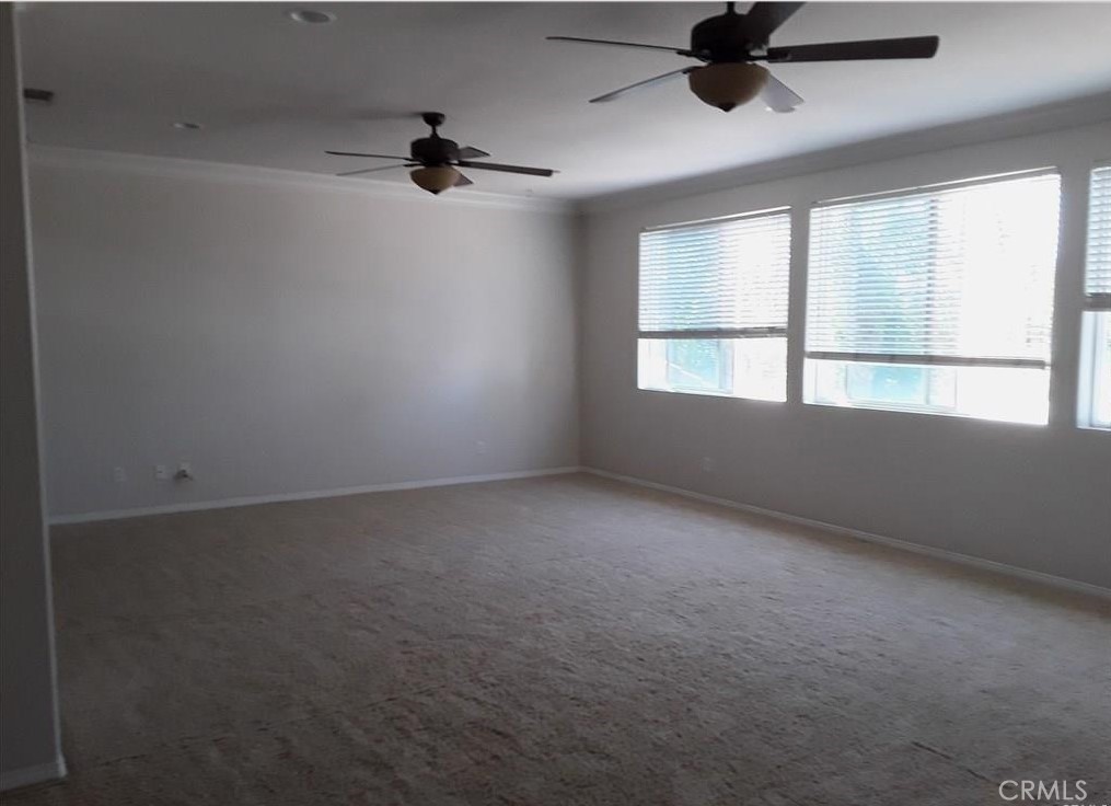 12701 Palm View Way Riverside, CA 92503 - Photo 24 of 26 an empty room with a window and a ceiling fan