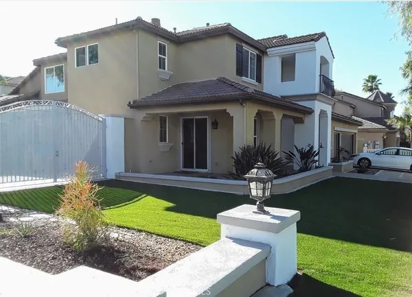 a front view of a house with a yard table and chairs