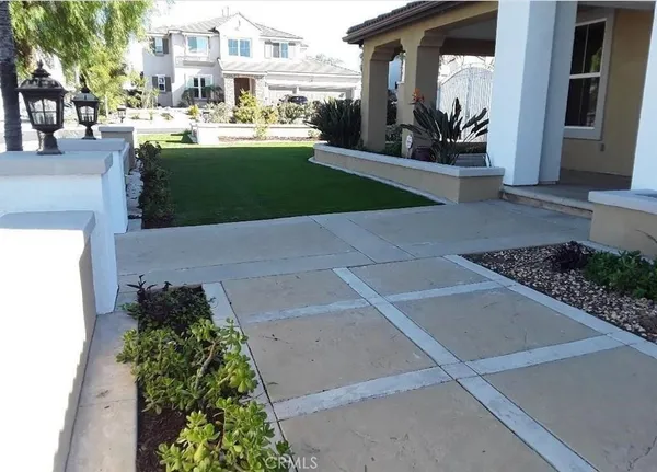 a view of a house with a garden and pathway