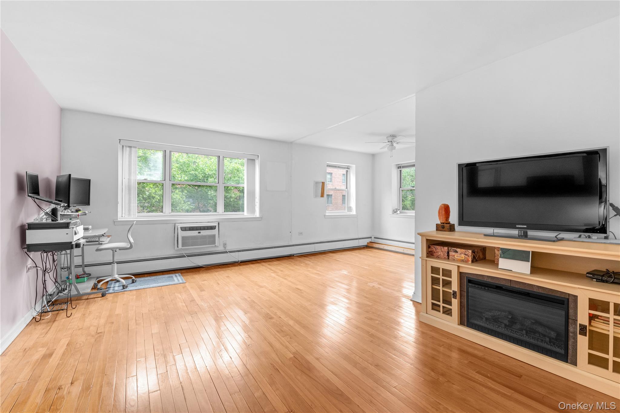 99-10 60th Avenue, Unit 3B Queens, NY 11368 - Photo 11 of 27 a living room with furniture and flat screen tv