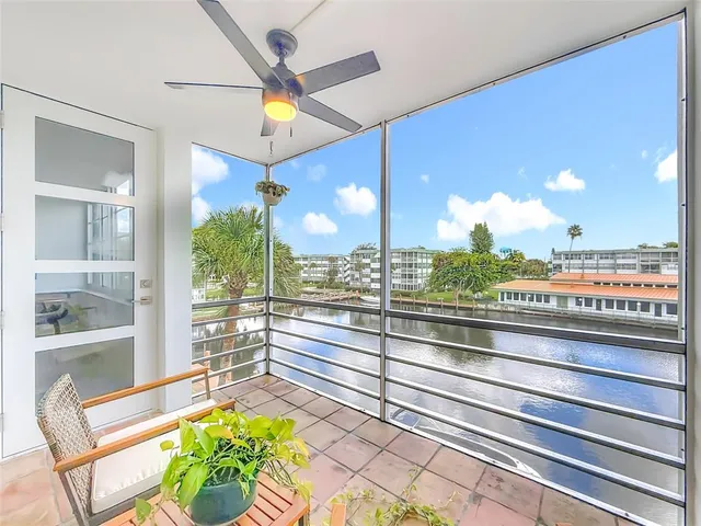 a view of a living room and a floor to ceiling window or kitchen