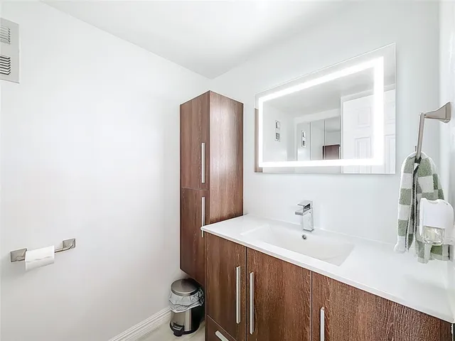 a yellow and red sign sitting in front of a building