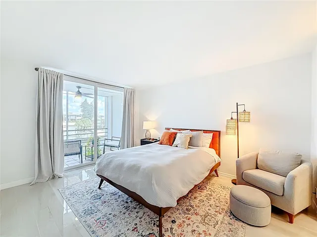 a living room with furniture a lamp and a floor to ceiling window