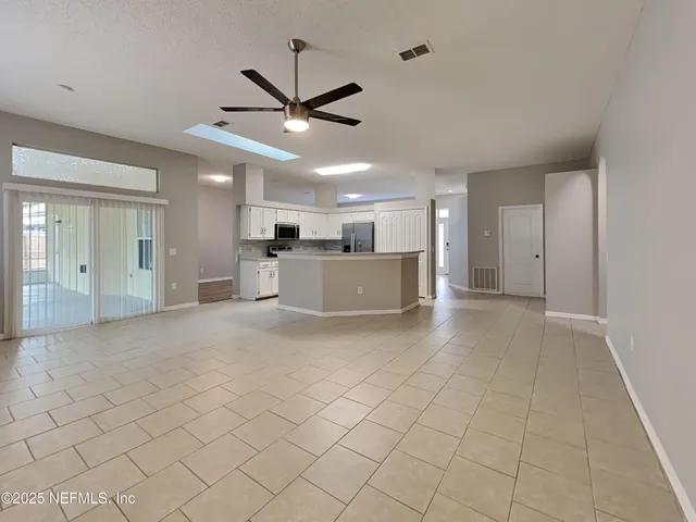 a view of a livingroom with a ceiling fan a ceiling fan and window