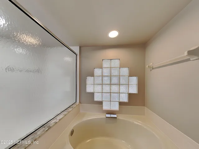 a bathroom with a bathtub and shower