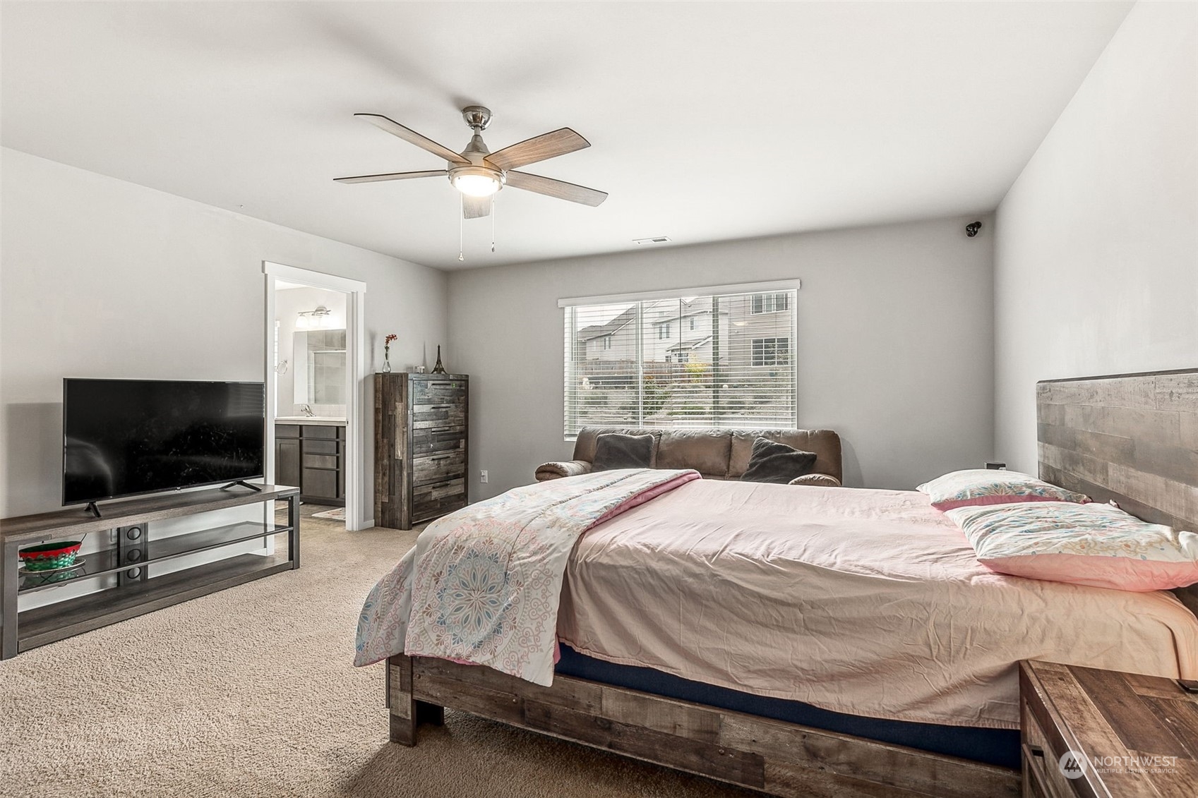 2926 Fiddleback Street Northeast Lacey, WA 98516 - Photo 14 of 29 a bedroom with a bed and a flat screen tv