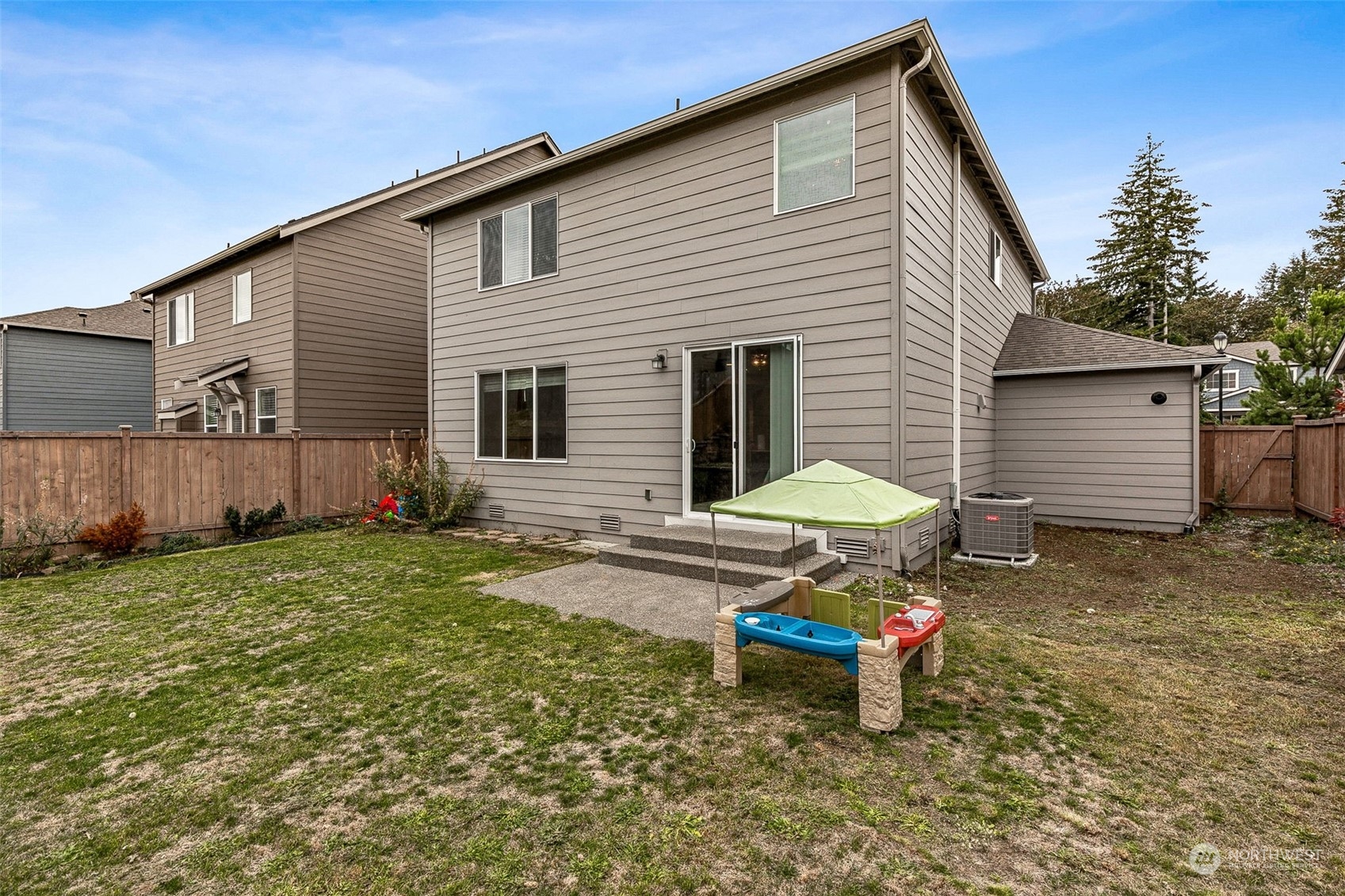 2926 Fiddleback Street Northeast Lacey, WA 98516 - Photo 23 of 29 a backyard of a house with a table and chairs