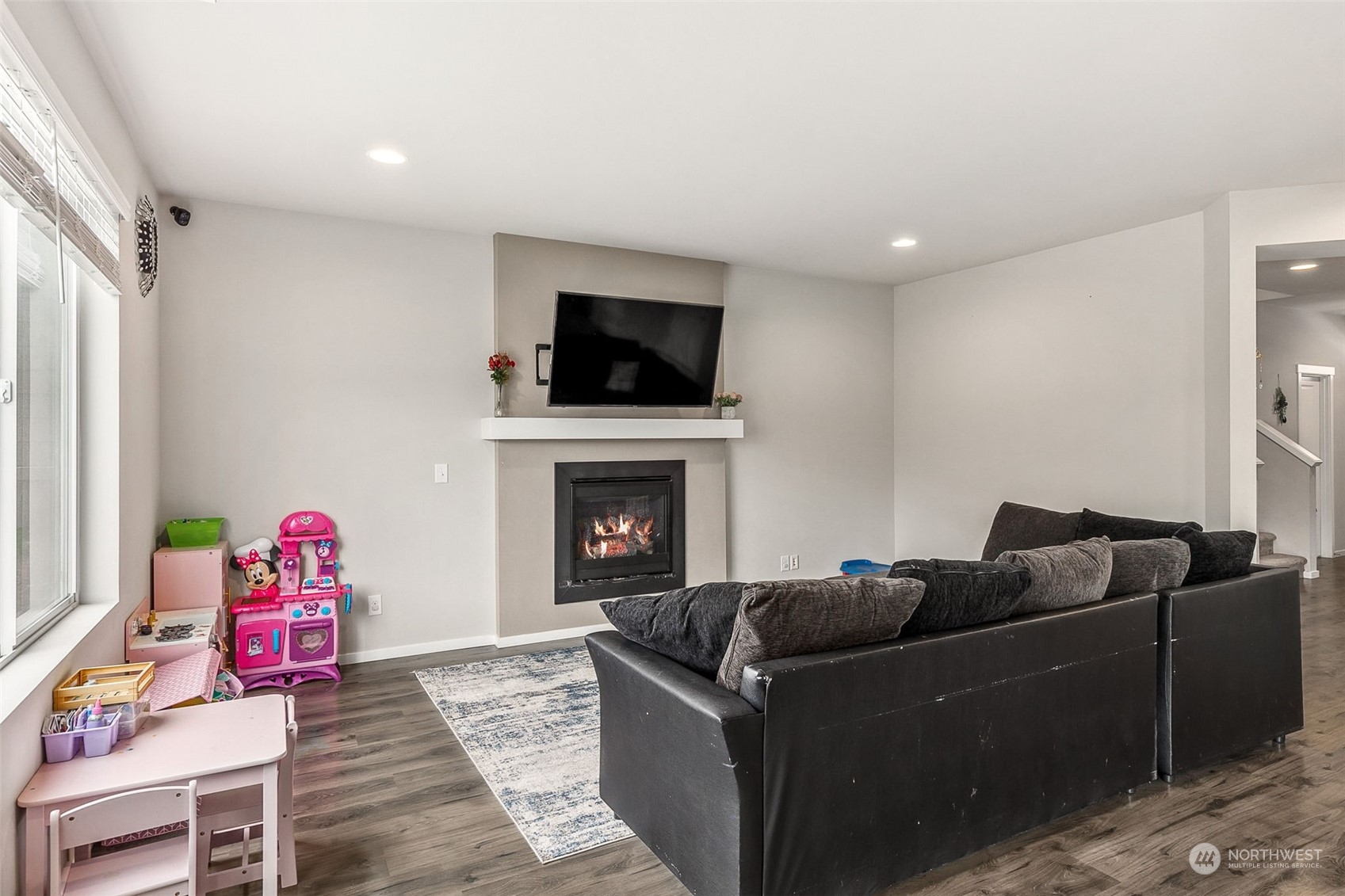2926 Fiddleback Street Northeast Lacey, WA 98516 - Photo 6 of 29 a living room with furniture a flat screen tv and a fireplace
