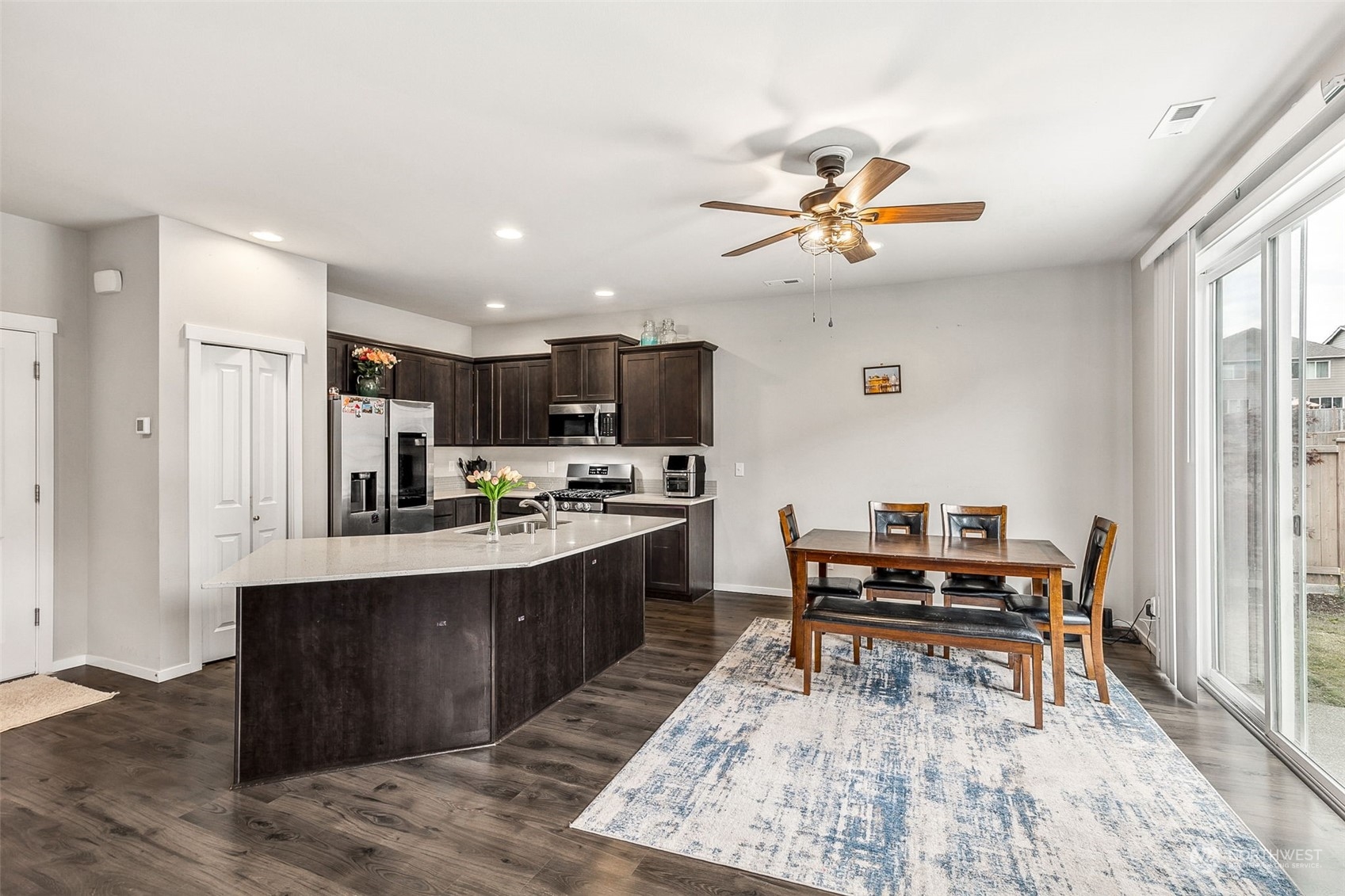 2926 Fiddleback Street Northeast Lacey, WA 98516 - Photo 8 of 29 a kitchen with stainless steel appliances kitchen island granite countertop a sink and a refrigerator