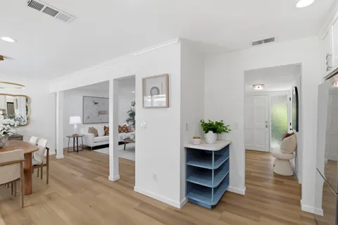 a kitchen with granite countertop stainless steel appliances a sink cabinets and a refrigerator