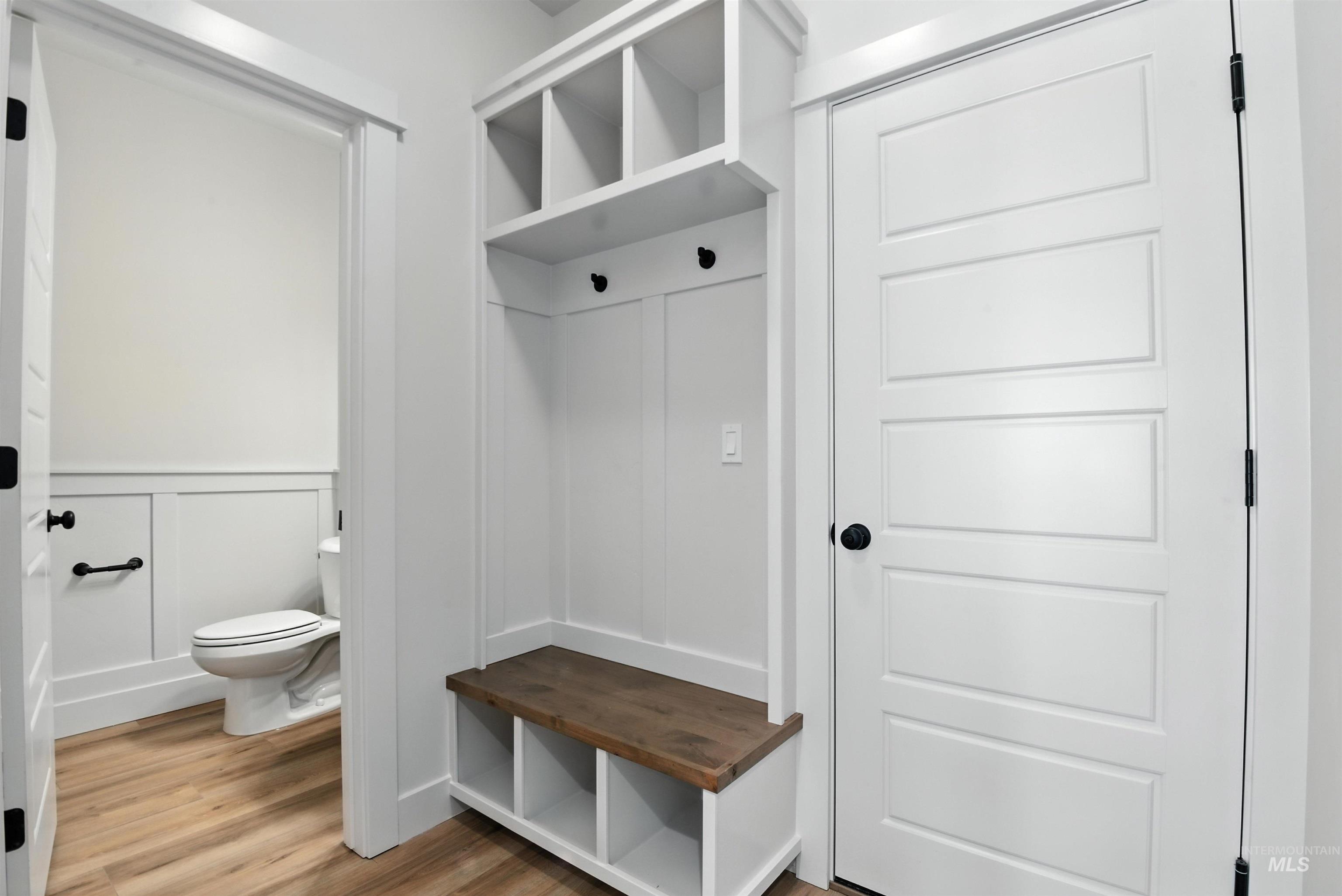 3521 South El Rio Avenue Boise, ID 83709 - Photo 19 of 38 Mudroom with a decorative wall, light wood-style flooring, and wainscoting
