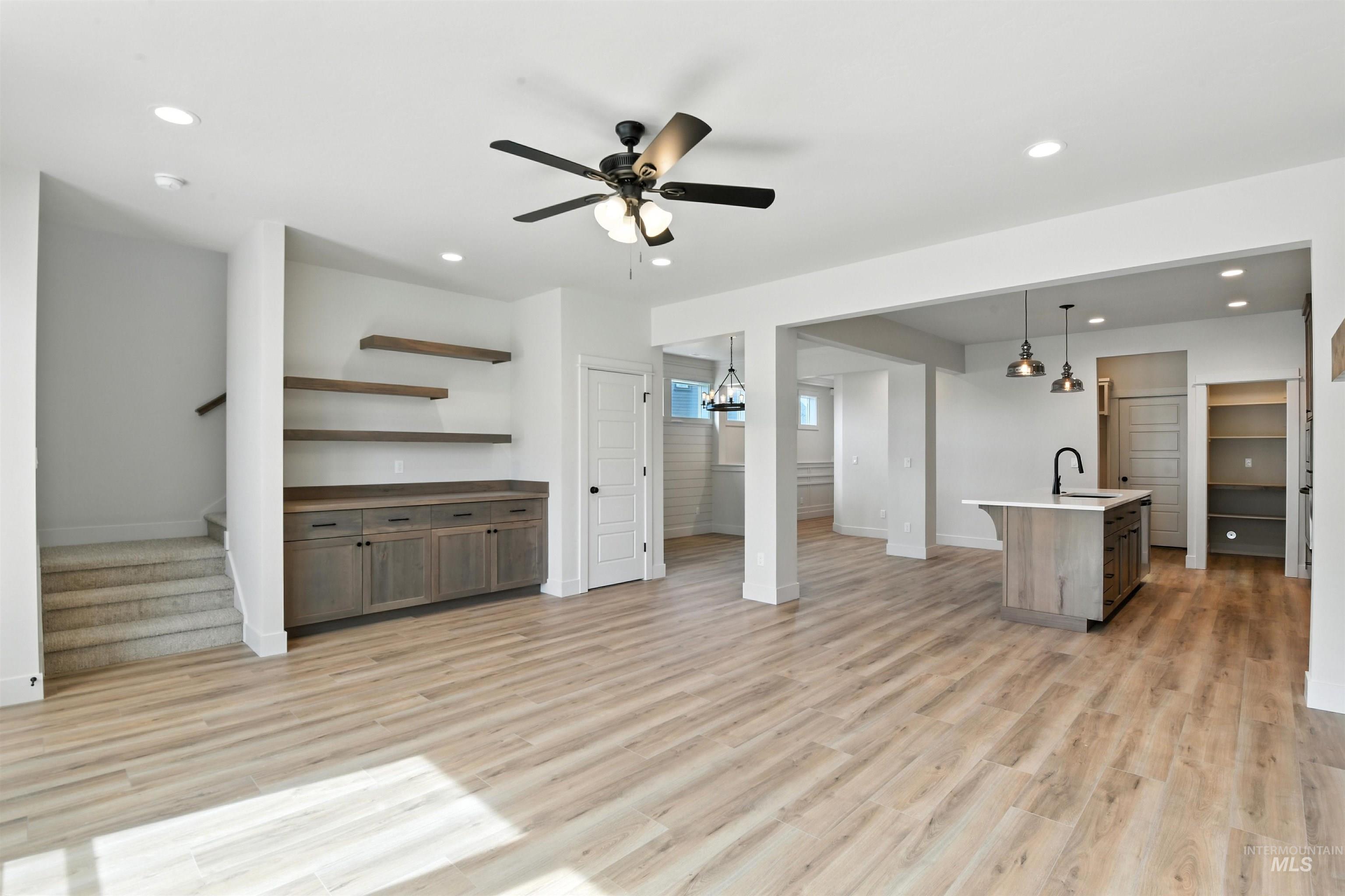 3521 South El Rio Avenue Boise, ID 83709 - Photo 24 of 38 Unfurnished living room with stairway, light wood-type flooring, recessed lighting, and a ceiling fan