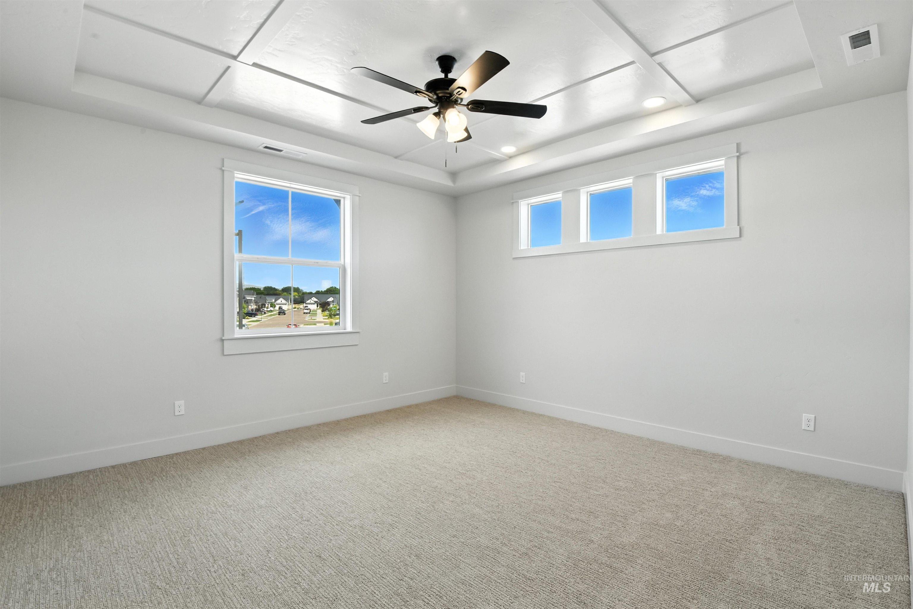 3521 South El Rio Avenue Boise, ID 83709 - Photo 29 of 38 Empty room featuring a raised ceiling, a ceiling fan, light colored carpet, and recessed lighting