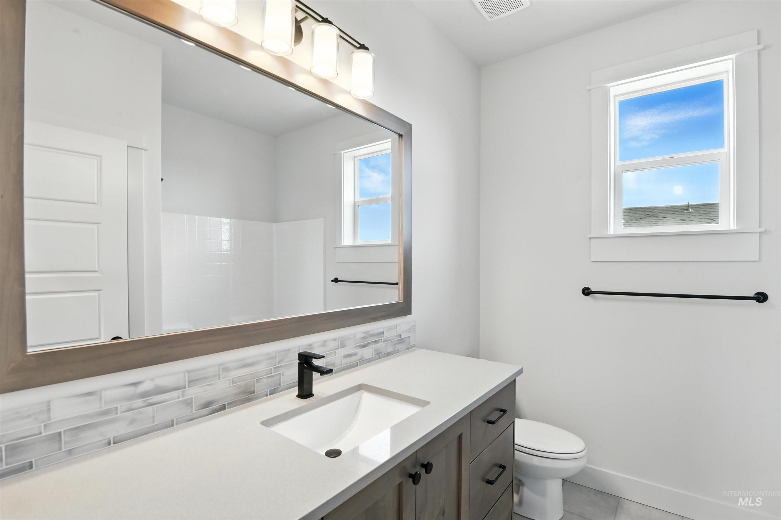 3521 South El Rio Avenue Boise, ID 83709 - Photo 30 of 38 Full bath featuring decorative backsplash, vanity, and tile patterned floors
