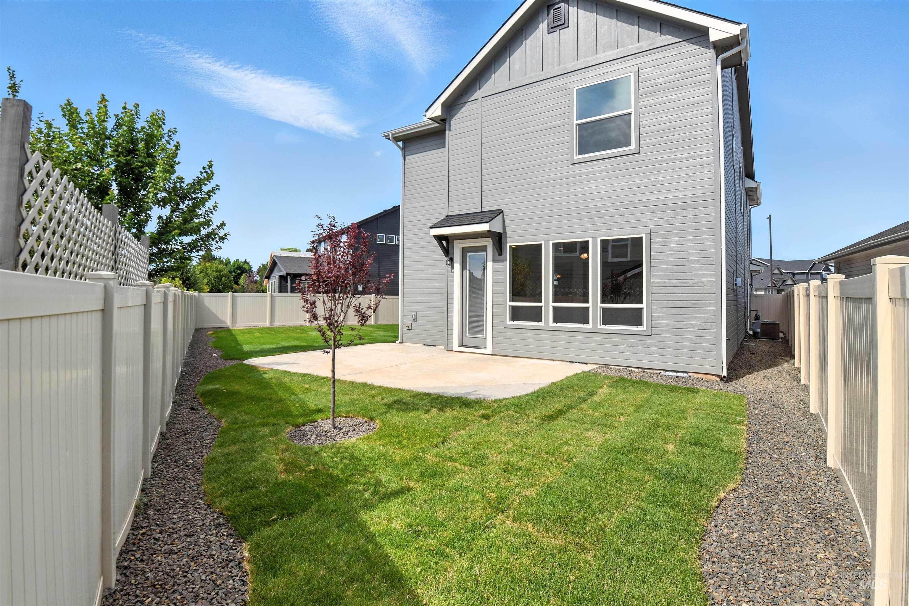 3521 South El Rio Avenue Boise, ID 83709 - Photo 35 of 38 Back of house featuring a patio area, a fenced backyard, and board and batten siding