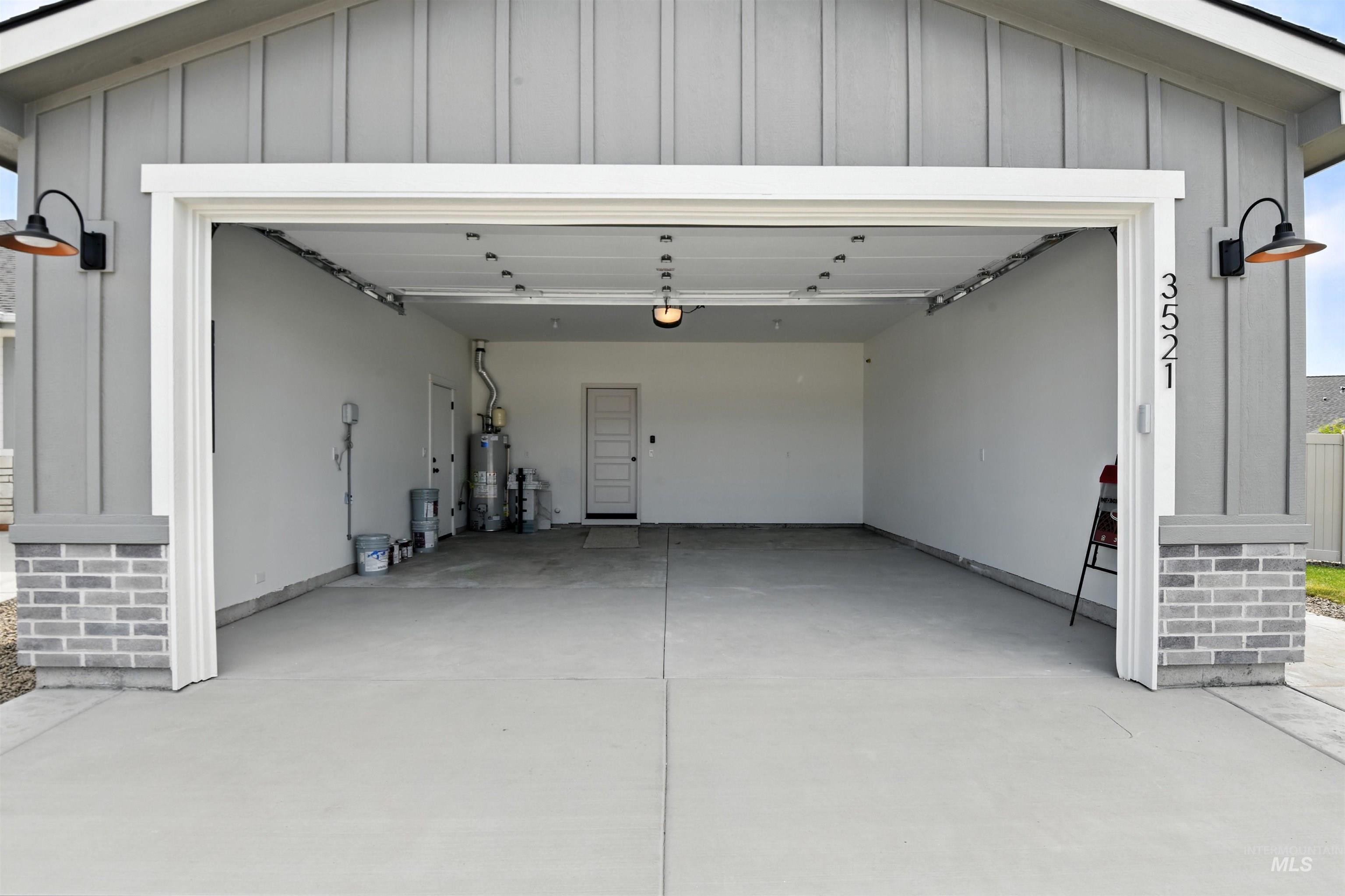 3521 South El Rio Avenue Boise, ID 83709 - Photo 38 of 38 Garage with gas water heater, concrete driveway, and a garage door opener