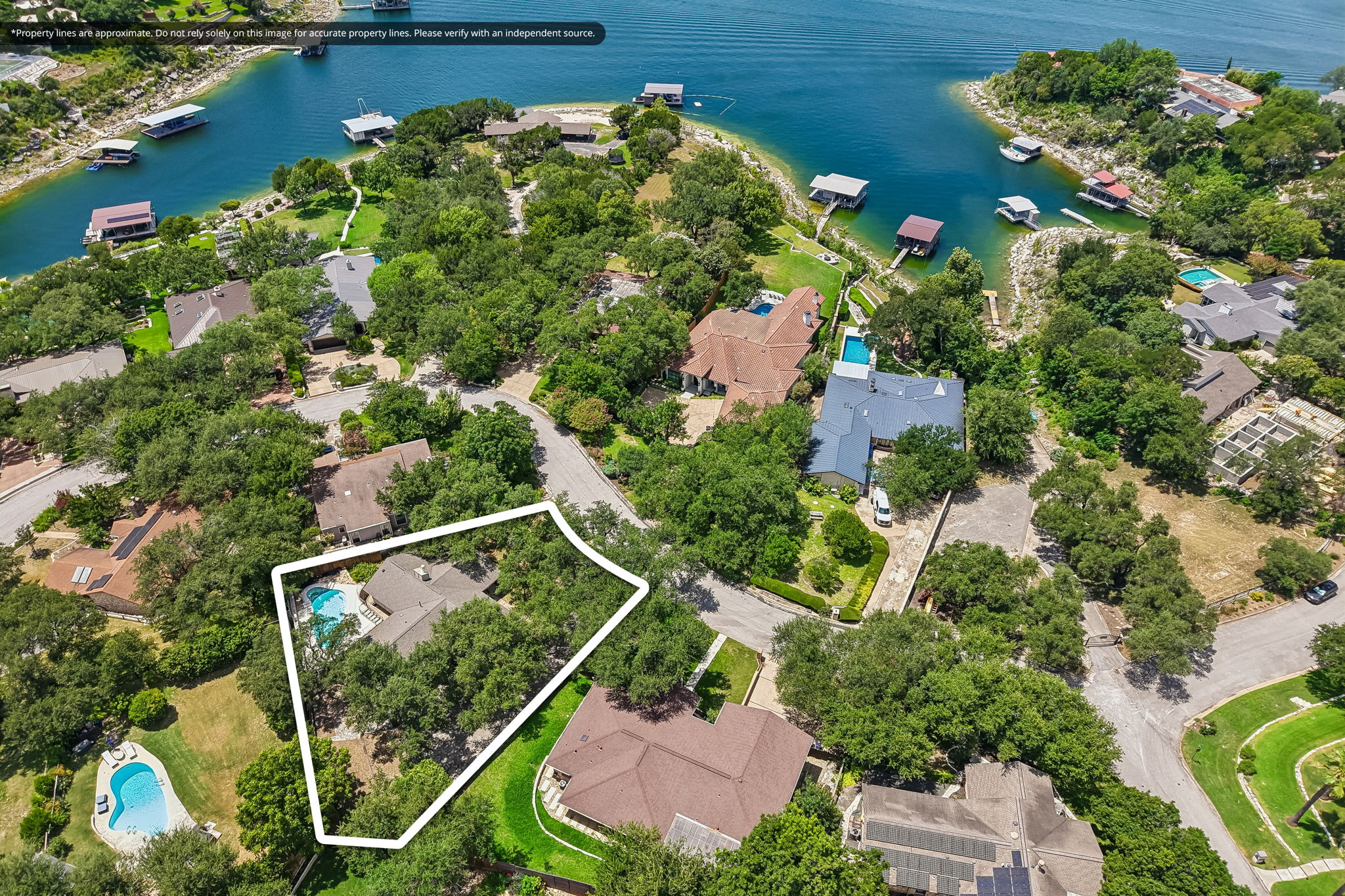 13101 Travis View Loop Austin, TX 78732 - Photo 27 of 27 Discover a tranquil lakeside retreat with mature trees and a private pool, perfect for serene living.