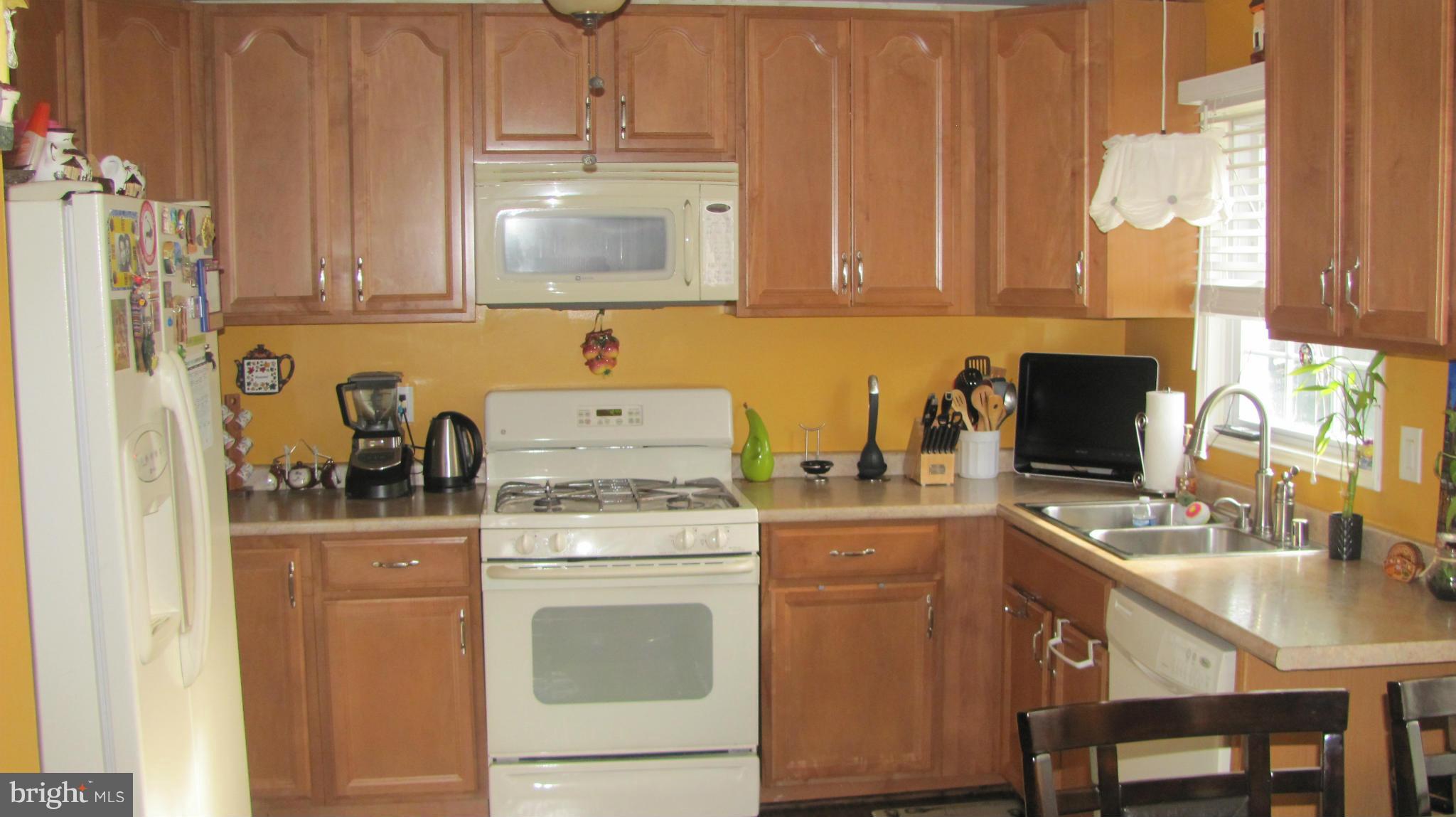 2929 Gracefield Road Silver Spring, MD 20904 - Photo 4 of 25 a kitchen with stainless steel appliances granite countertop a sink stove and cabinets