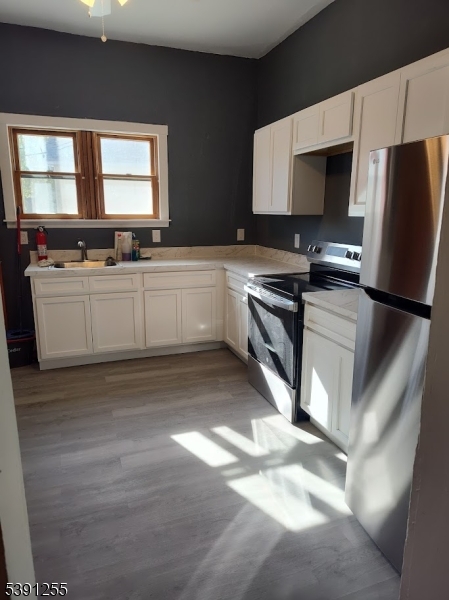 304 Front Street, Unit 4B Belvidere, NJ 07823 - Photo 6 of 8 a kitchen with stainless steel appliances granite countertop a stove a sink and a microwave