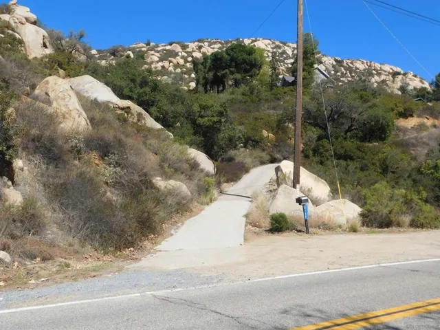 a view of a road with a trees in the background