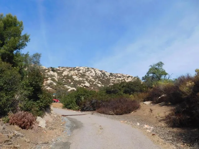 a view of a dry yard with mountains in the background