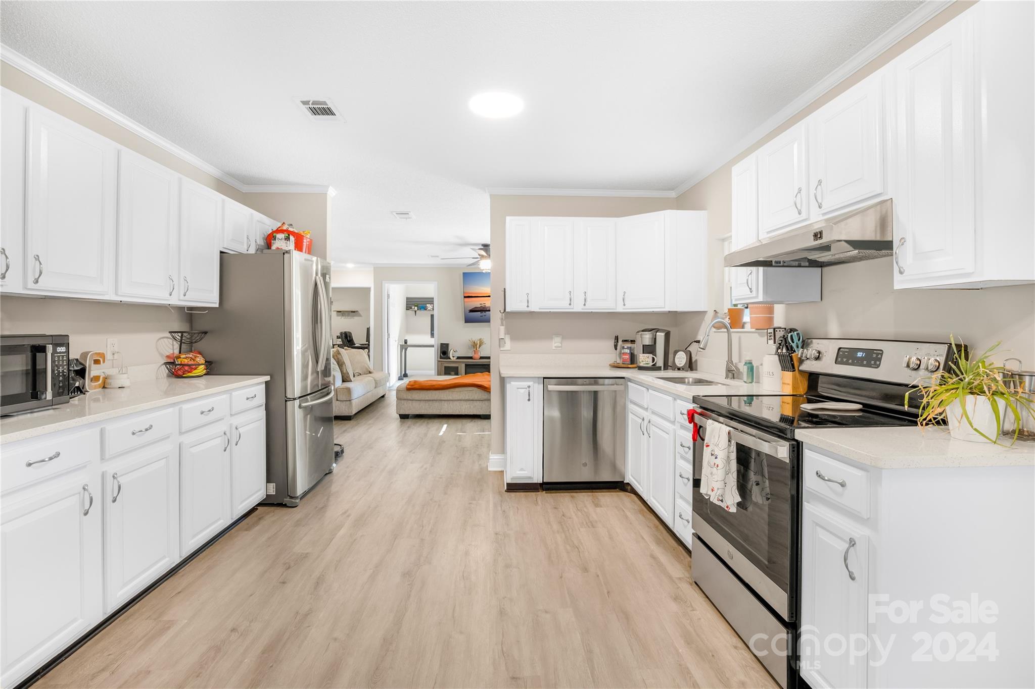 1335 Old York Road Chester, SC 29706 - Photo 11 of 33 a kitchen with cabinets wooden floor and stainless steel appliances