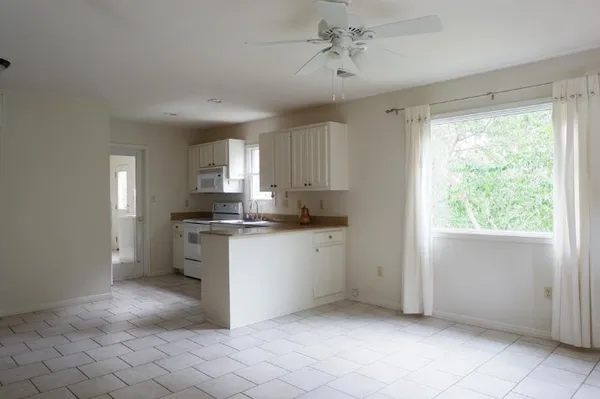 a kitchen with a refrigerator and window