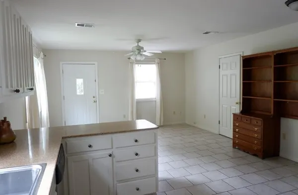 a kitchen with granite countertop a refrigerator and a sink