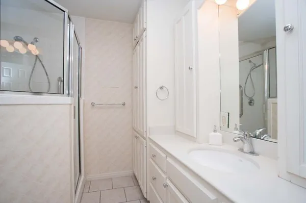 a bathroom with a double vanity sink and mirror