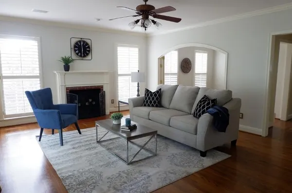 a living room with furniture and a fireplace