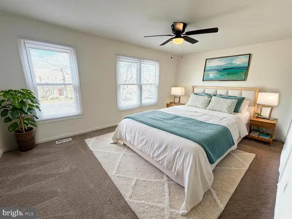 a spacious bedroom with a bed and a chandelier