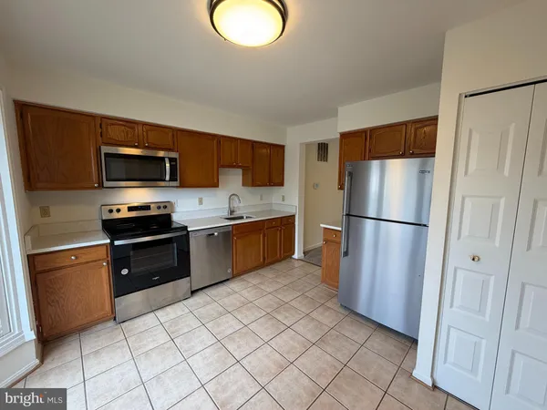 a kitchen with a refrigerator sink and microwave