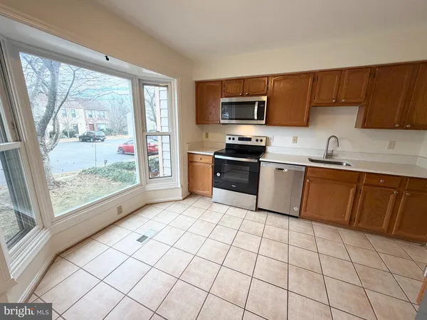 a kitchen with stainless steel appliances a stove sink and cabinets