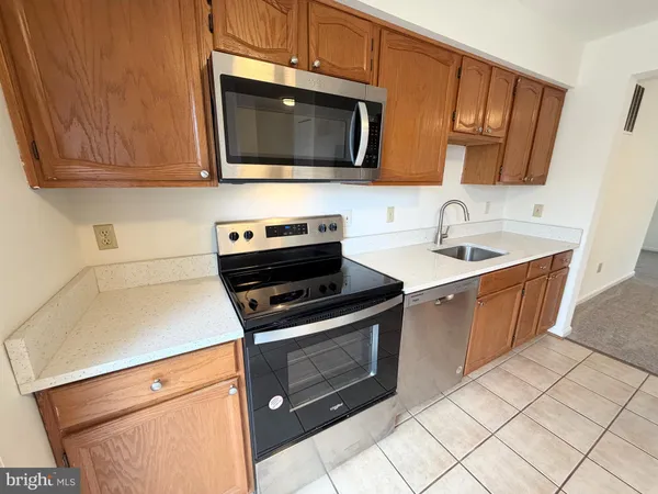a kitchen with stainless steel appliances granite countertop a sink stove and microwave