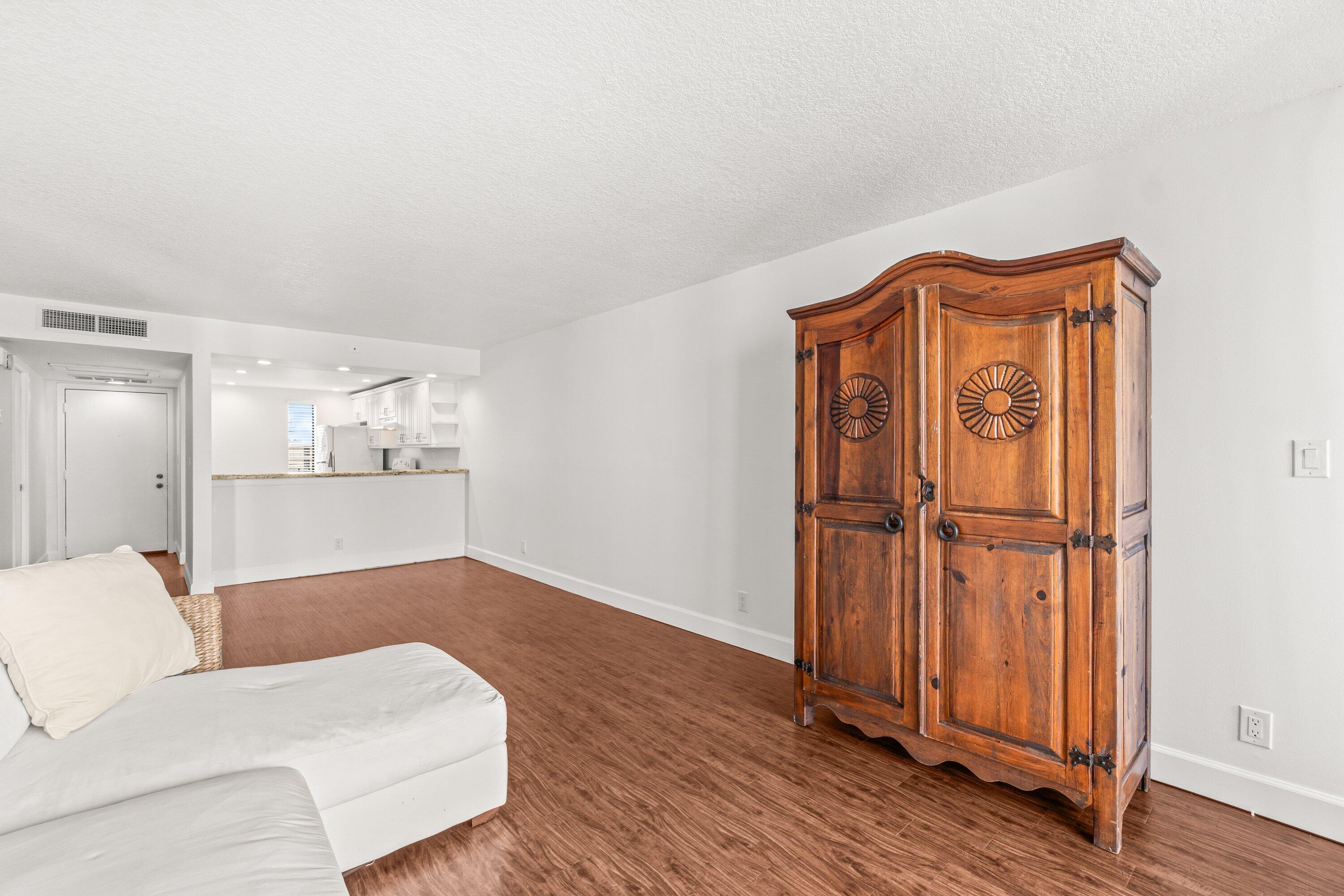 15 Royal Palm Way, Unit 604 Boca Raton, FL 33432 - Photo 14 of 41 a bedroom with a bed and wooden floor