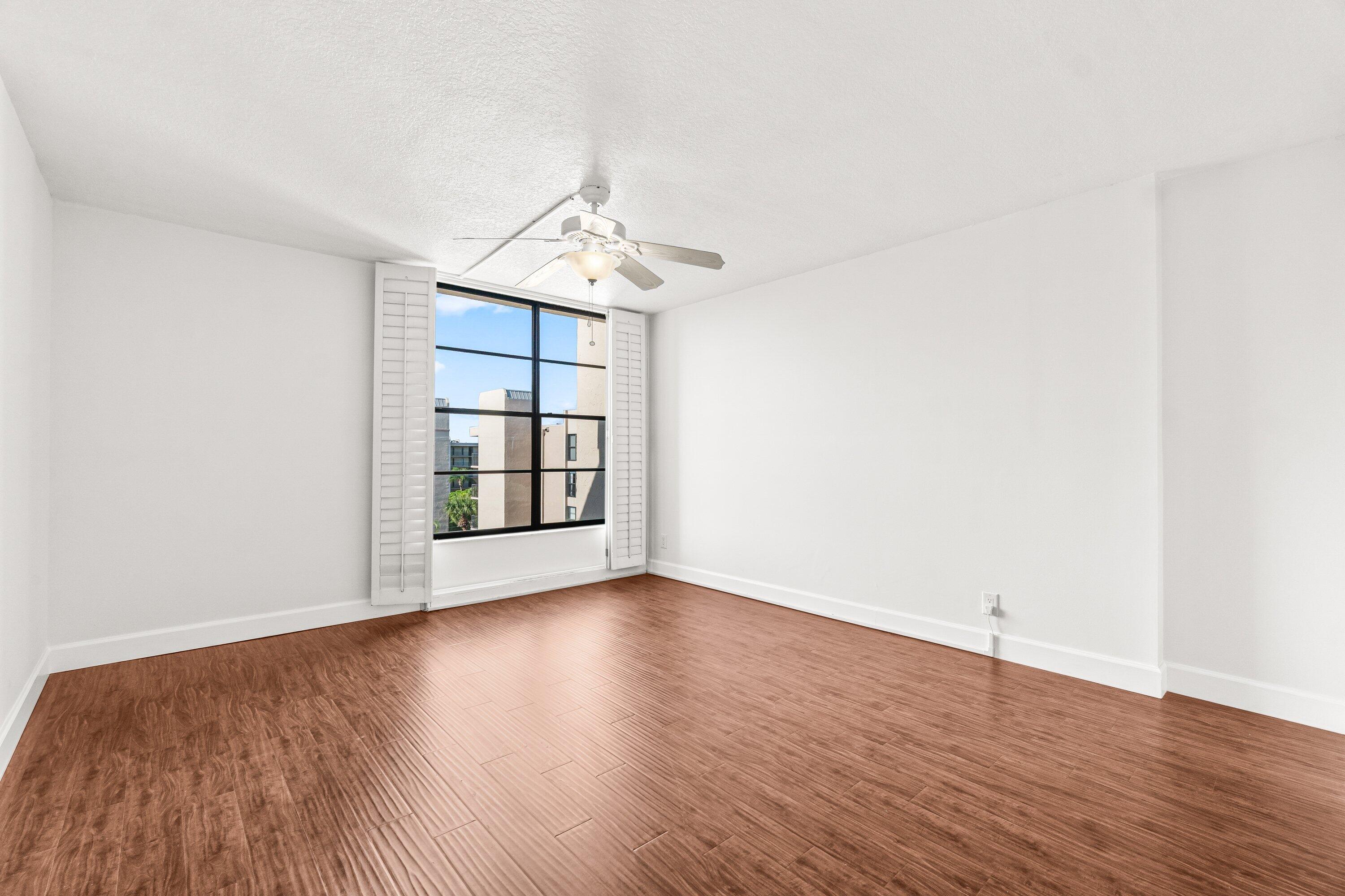 15 Royal Palm Way, Unit 604 Boca Raton, FL 33432 - Photo 18 of 41 a view of wooden floor and a chandelier in a room