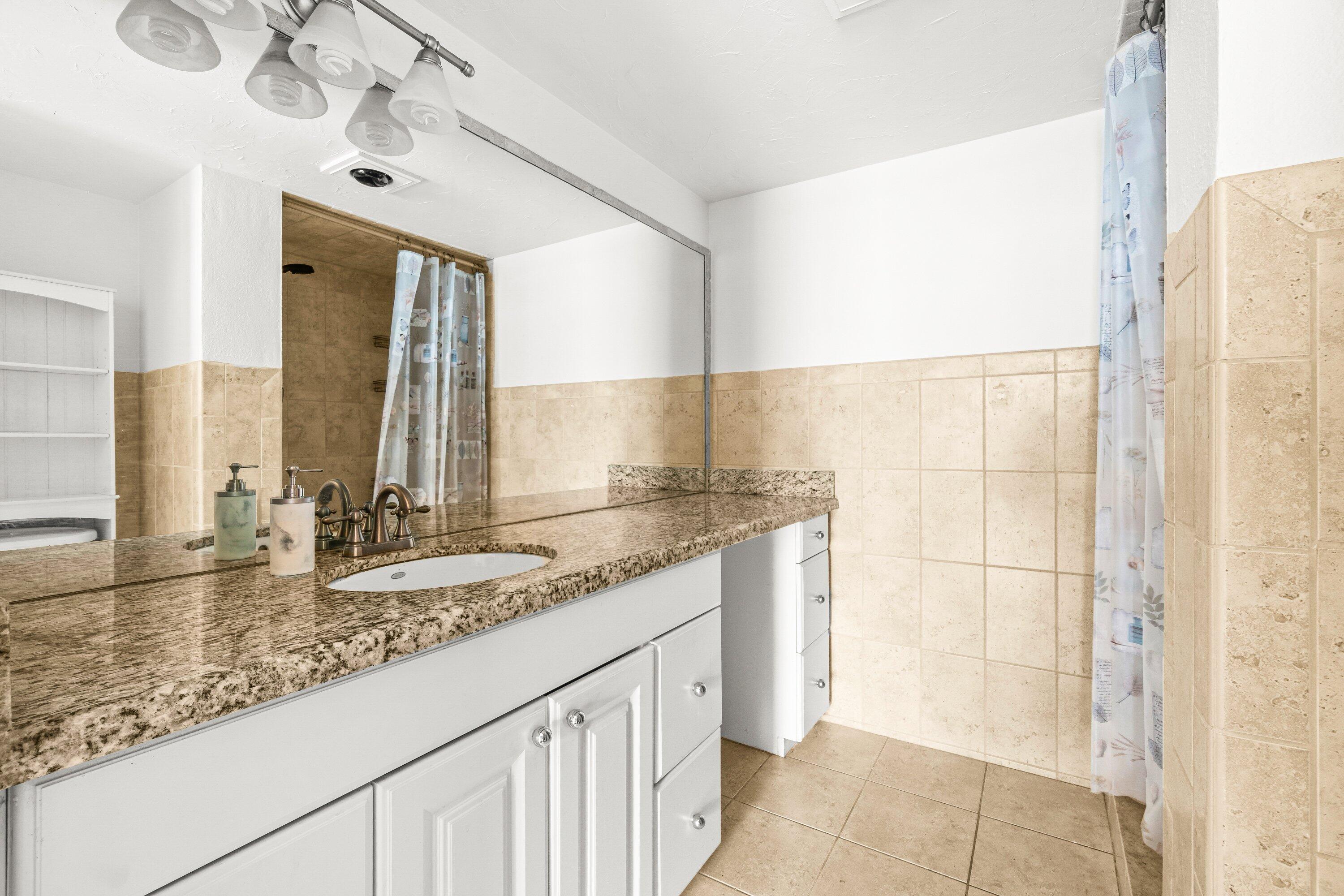 15 Royal Palm Way, Unit 604 Boca Raton, FL 33432 - Photo 22 of 41 a bathroom with a granite countertop sink and a mirror