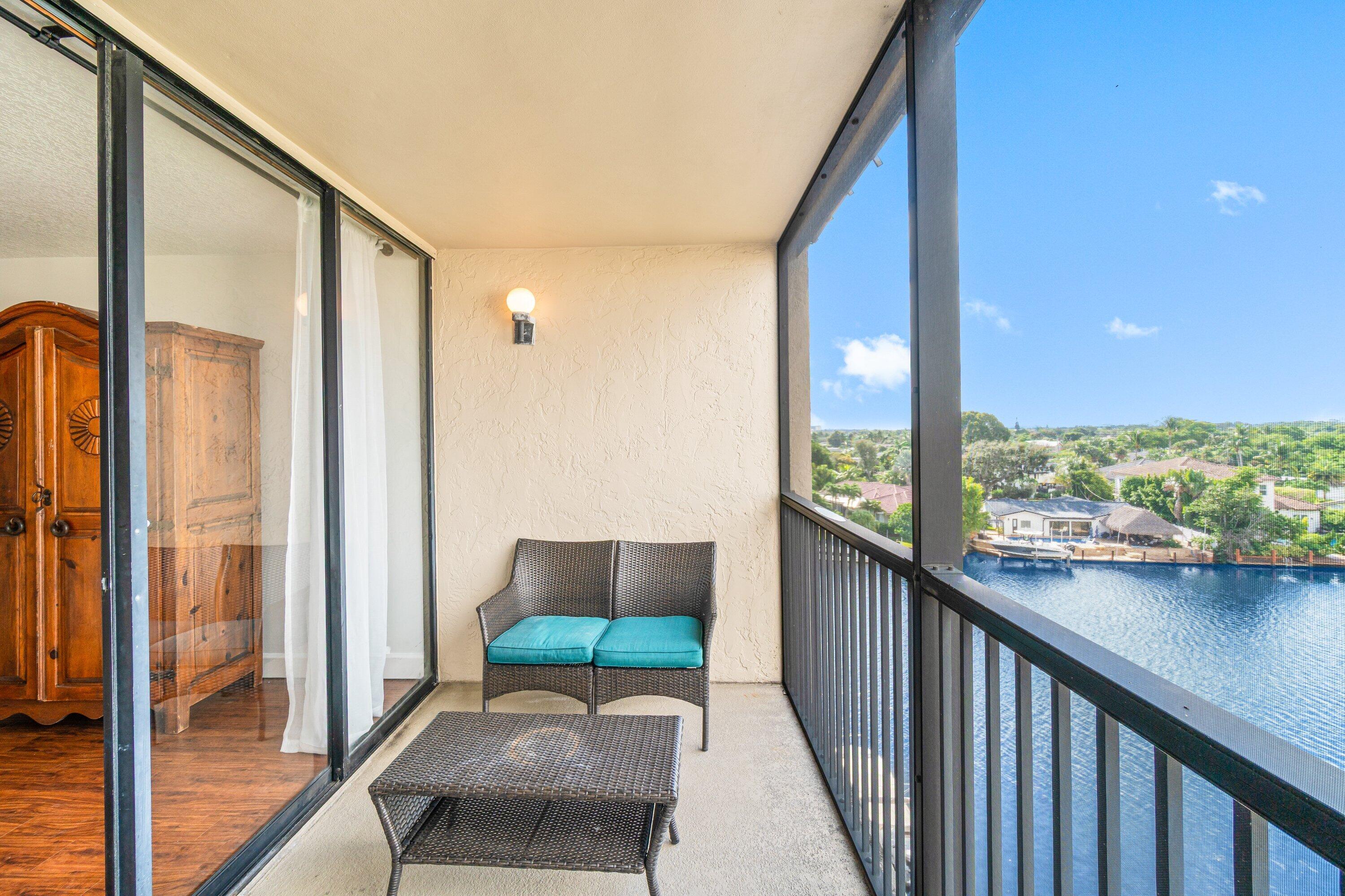 15 Royal Palm Way, Unit 604 Boca Raton, FL 33432 - Photo 27 of 41 a balcony with furniture and a floor to ceiling window