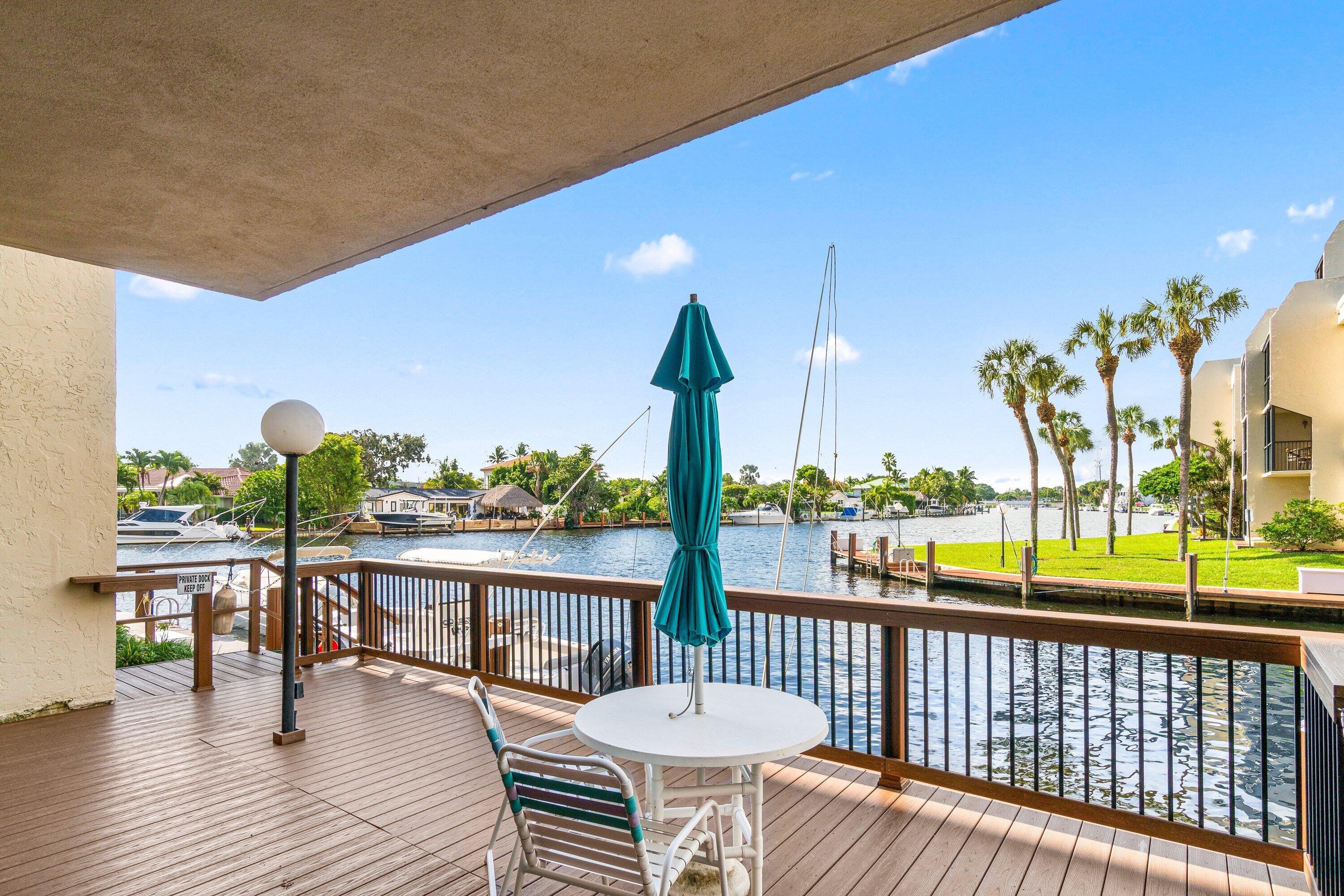 15 Royal Palm Way, Unit 604 Boca Raton, FL 33432 - Photo 31 of 41 a view of a chairs and table in patio with wooden floor