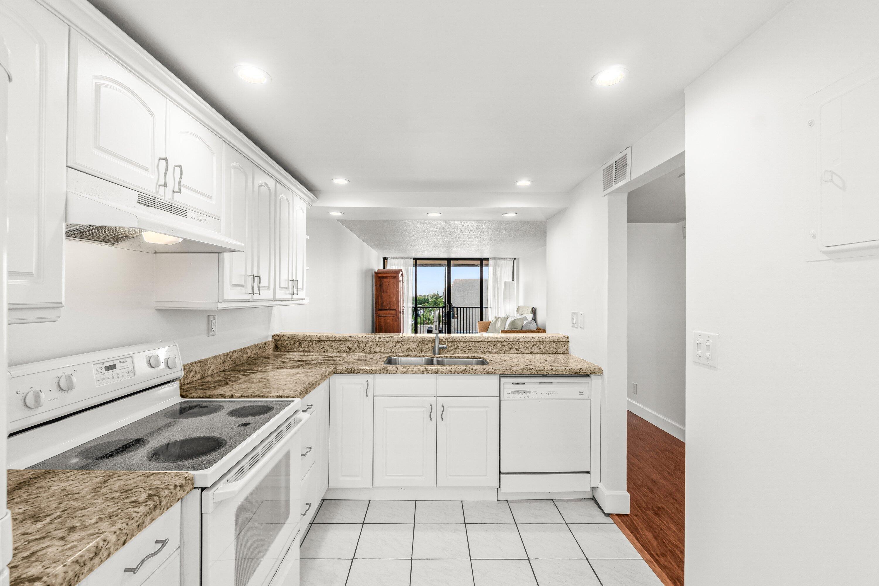 15 Royal Palm Way, Unit 604 Boca Raton, FL 33432 - Photo 7 of 41 a kitchen with a stove sink and cabinets