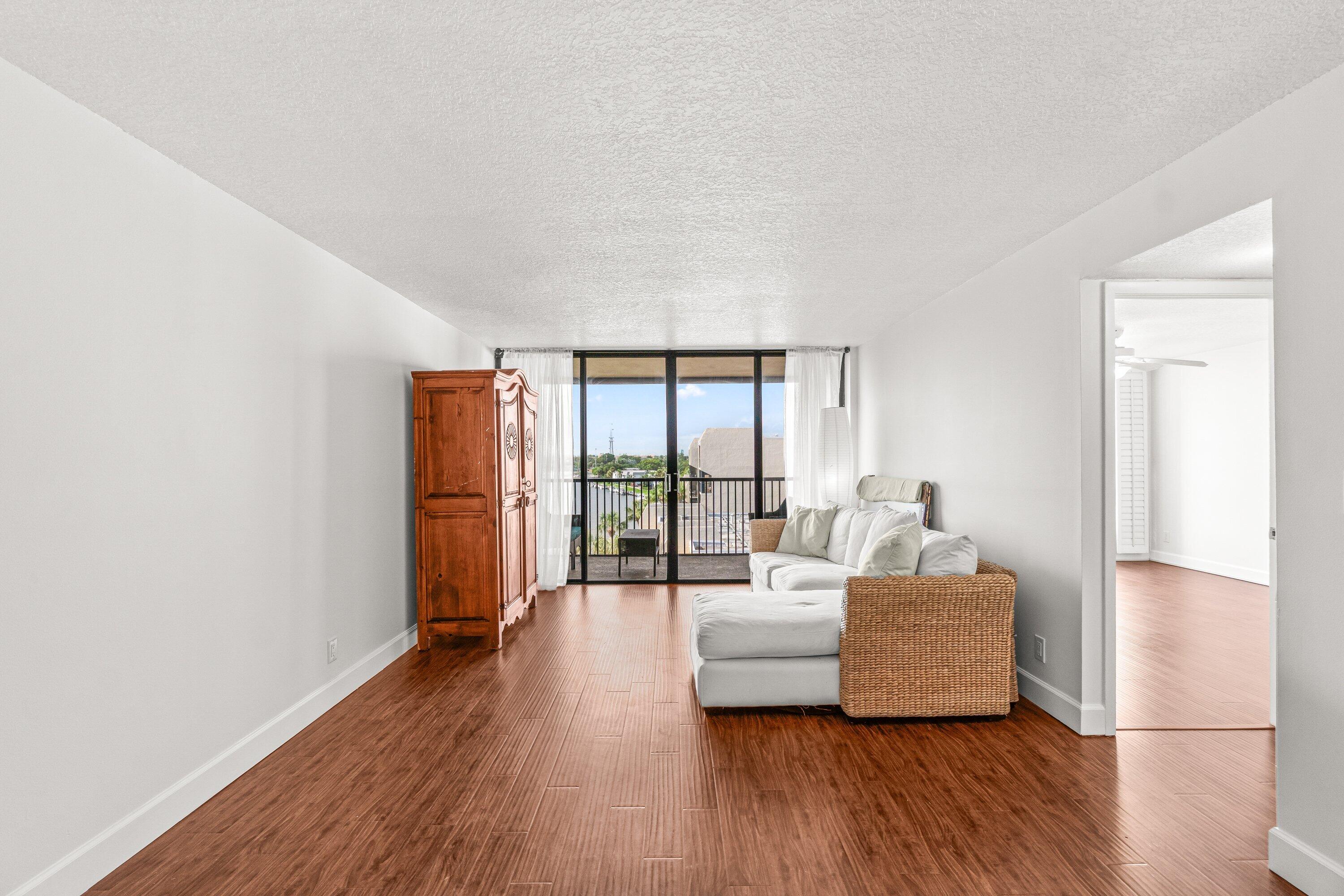 15 Royal Palm Way, Unit 604 Boca Raton, FL 33432 - Photo 10 of 41 a living room with furniture and a floor to ceiling window