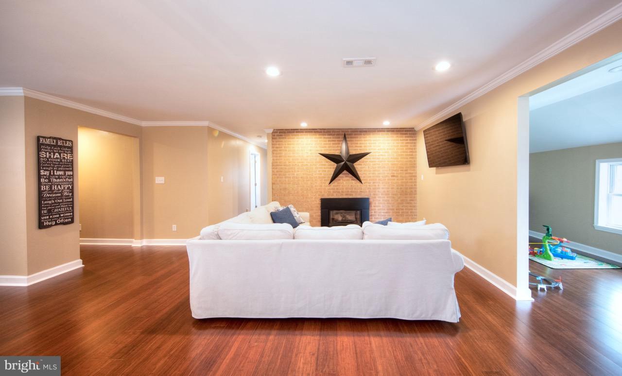 Living Room w/ gas fireplace, brick accent wall
