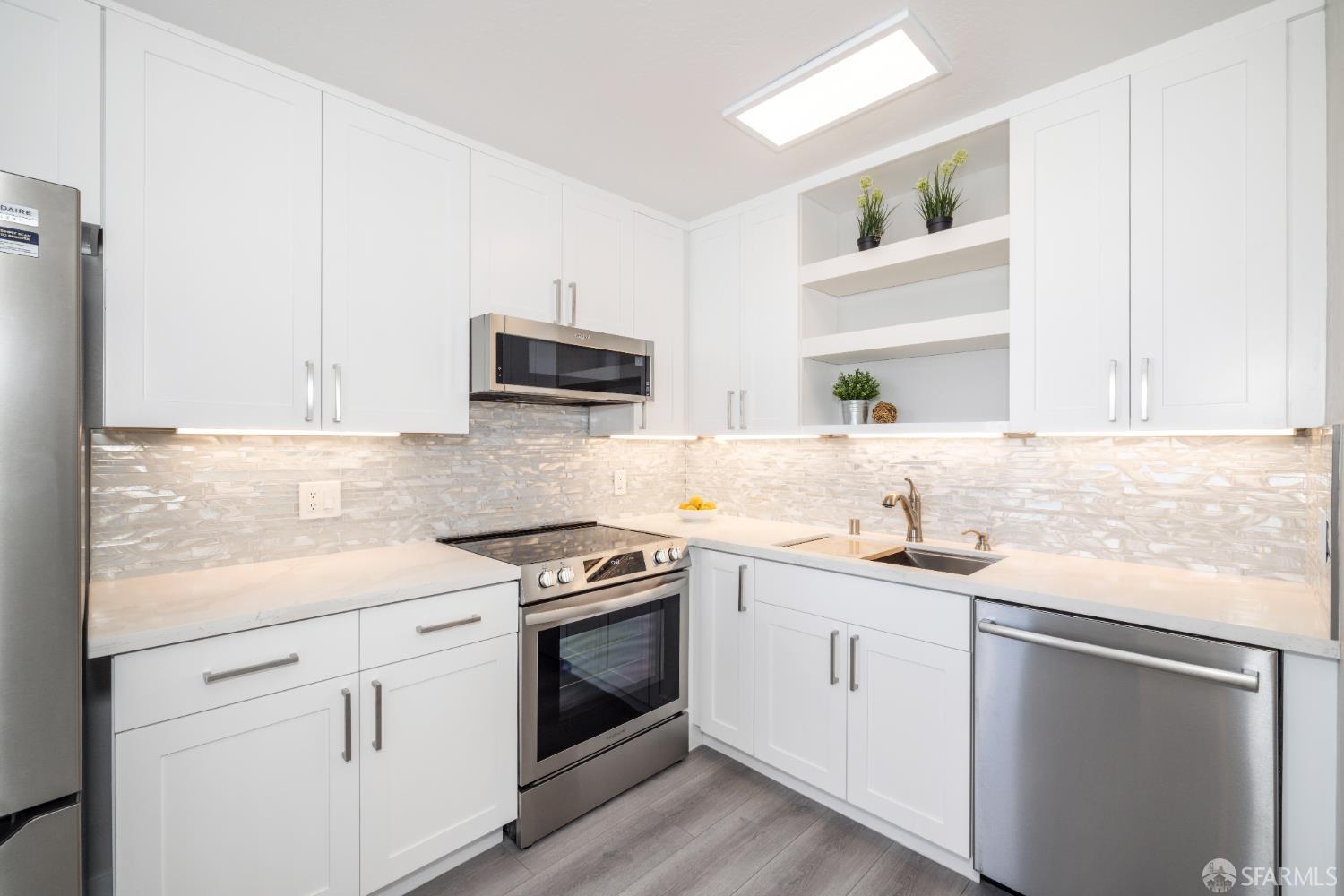 833 Corbett Avenue San Francisco, CA 94131 - Photo 18 of 22 a kitchen with granite countertop white cabinets sink and stainless steel appliances