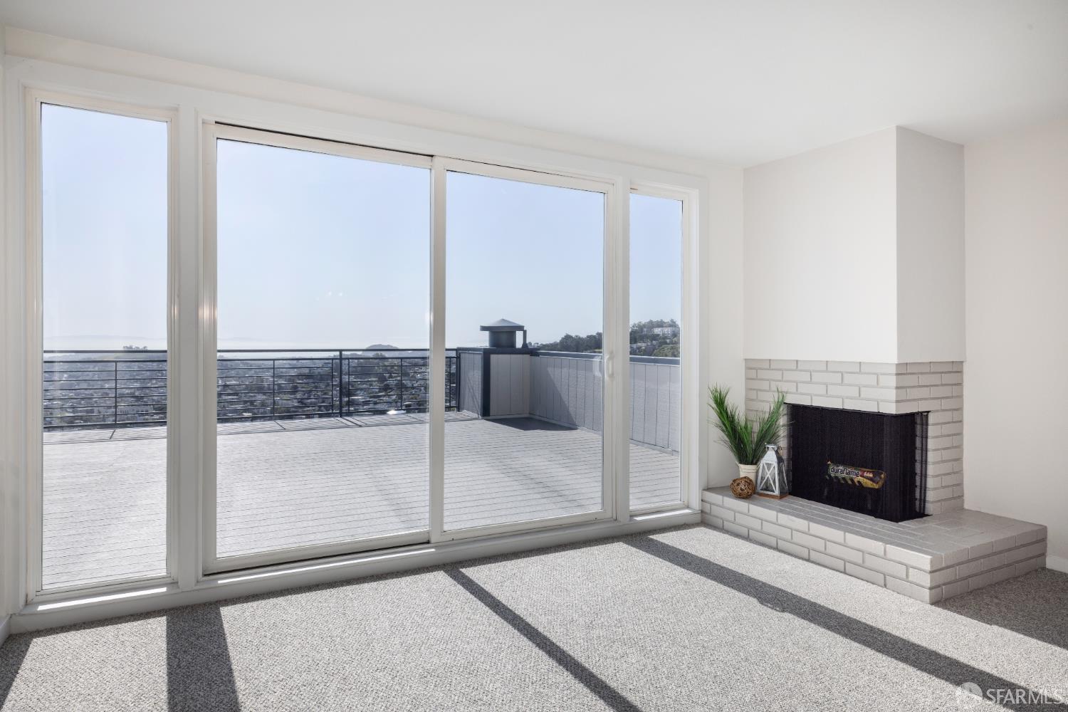 833 Corbett Avenue San Francisco, CA 94131 - Photo 21 of 22 a living room with a fireplace and a floor to ceiling window