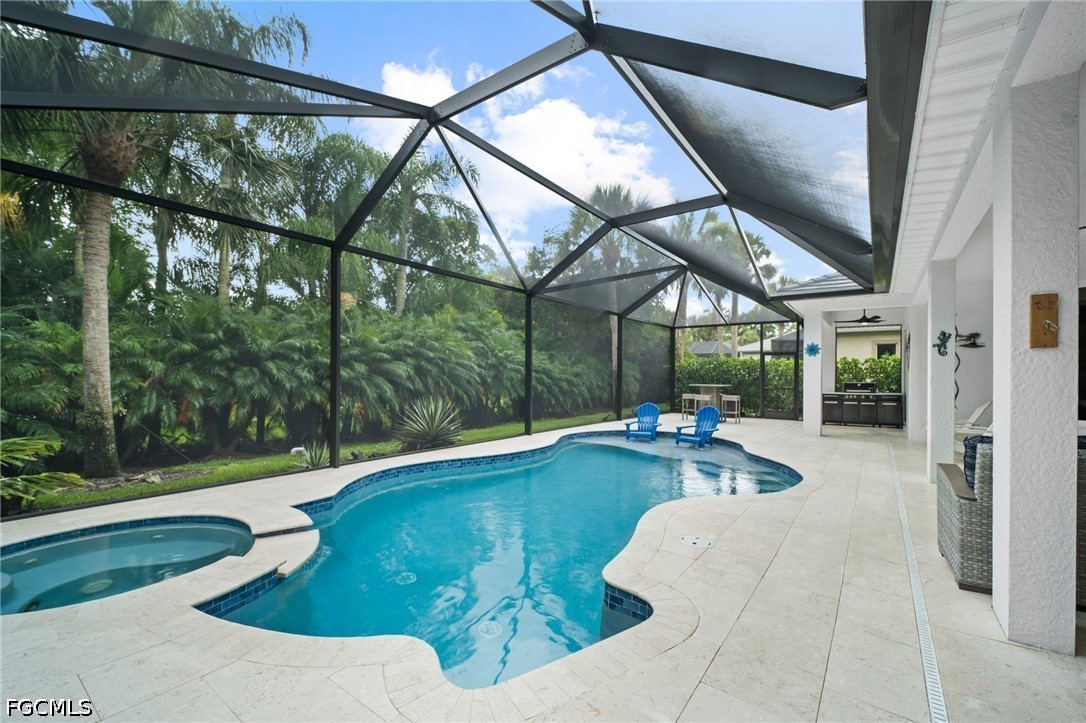 9042 Bronco Court Naples, FL 34113 - Photo 29 of 50 a view of a swimming pool with a patio