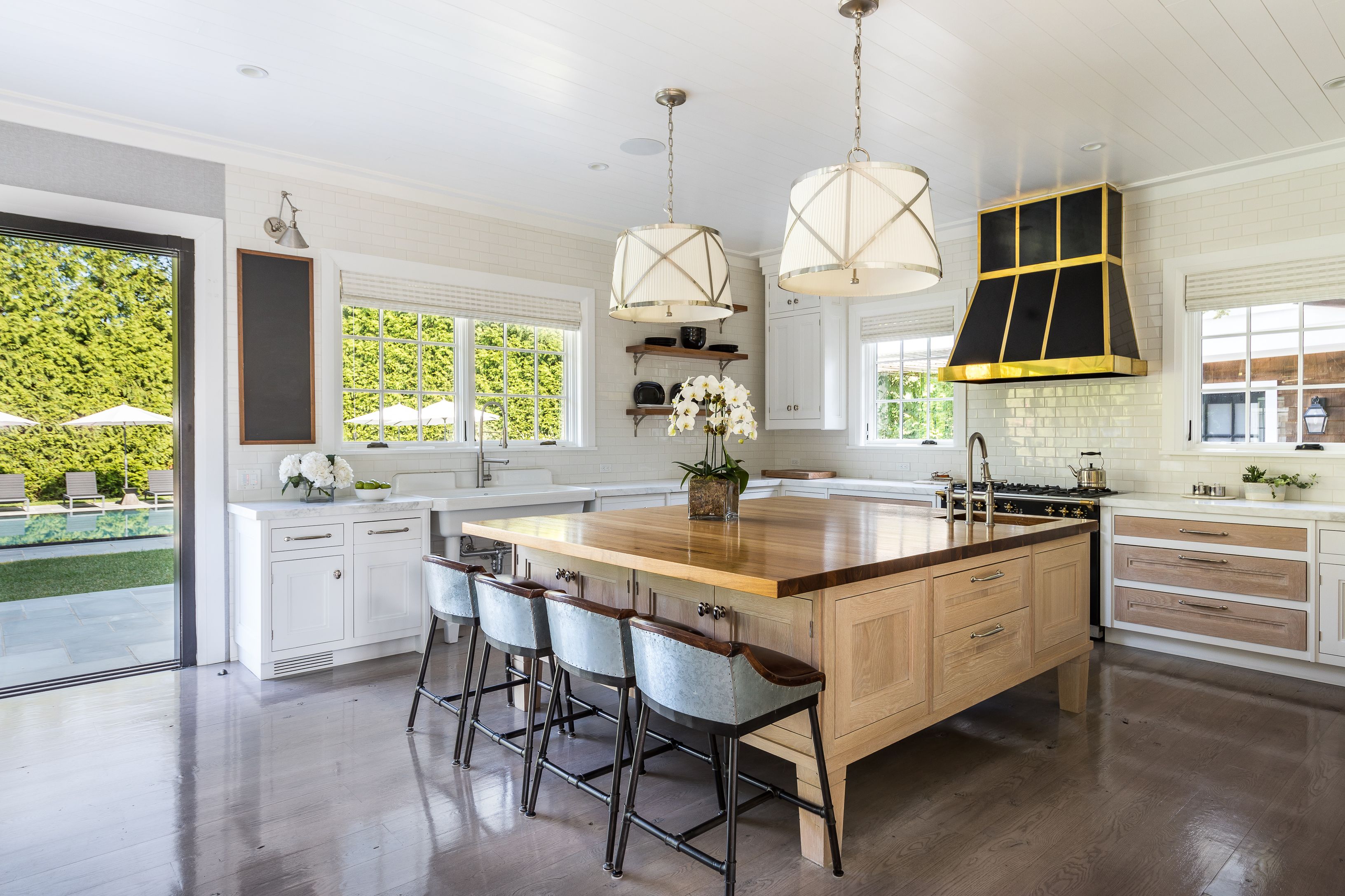 900 Head Of Pond Road Water Mill, NY 11976 - Photo 7 of 41 a kitchen with granite countertop a sink stainless steel appliances and white cabinets