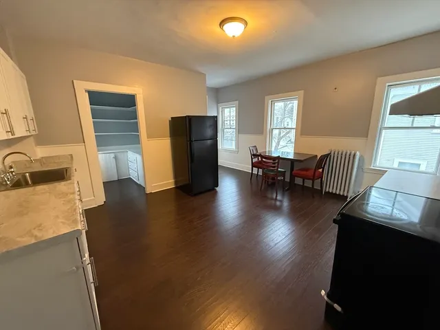 a view of kitchen with furniture and wooden floor