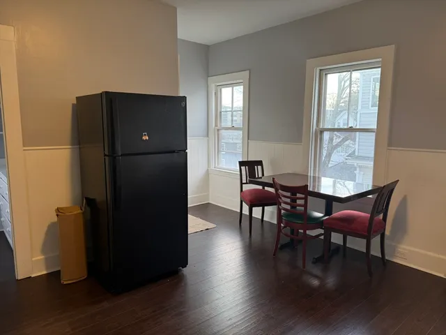 a dining room with furniture and wooden floor