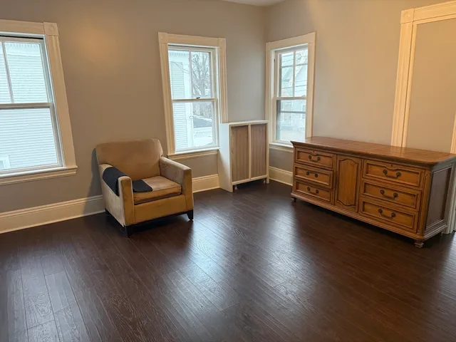 a room with wooden floors and pool table