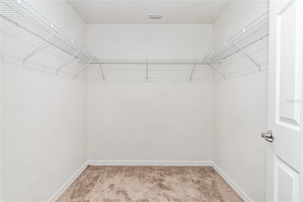 61 Larch Run Ocala, FL 34480 - Photo 12 of 26 a view of a room with racks on the wall